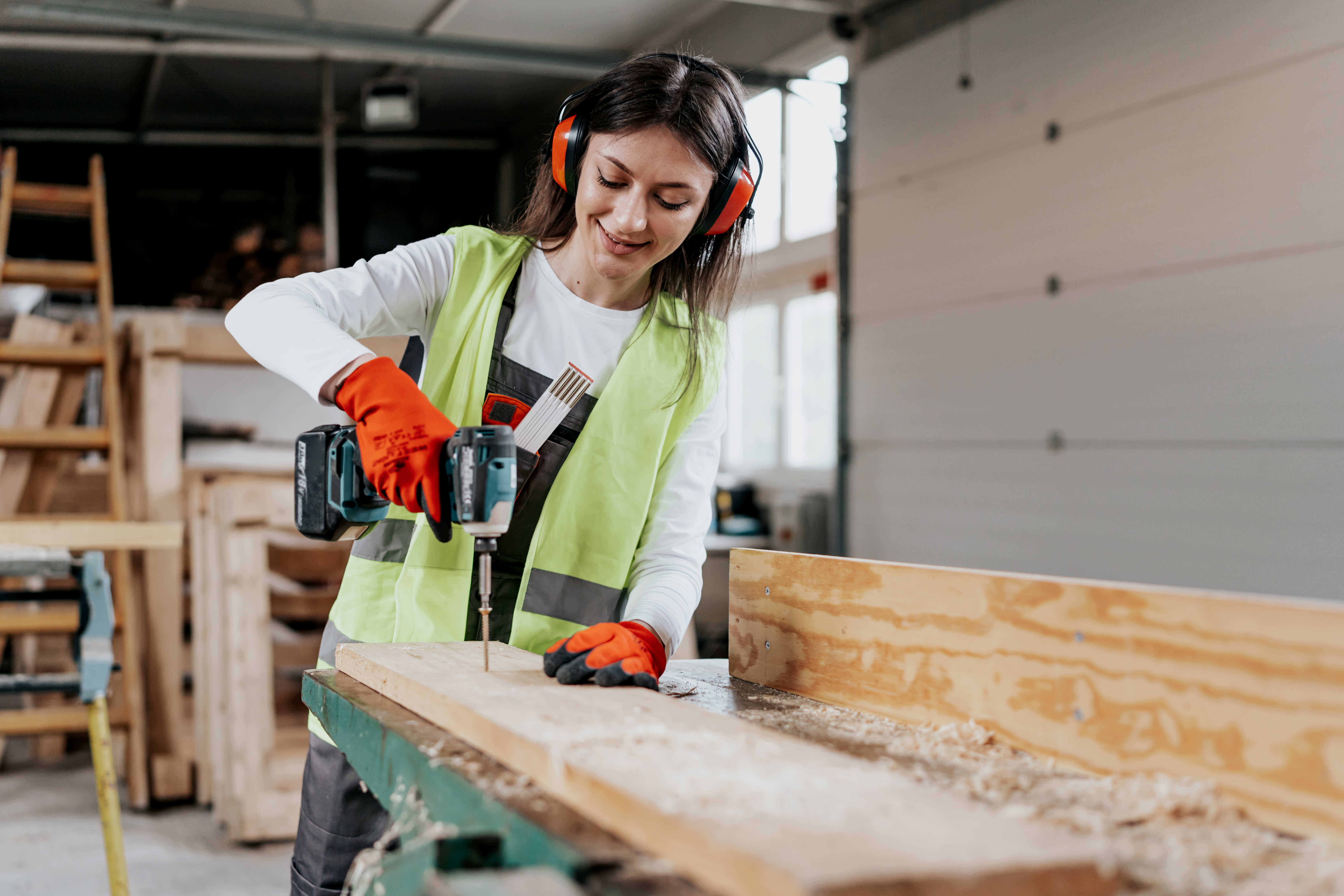 Female drilling into ply wood