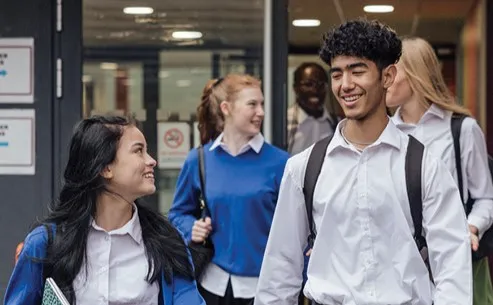 Two students walking away from school.